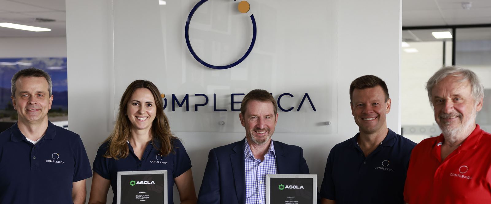 Complexica team members with industry awards